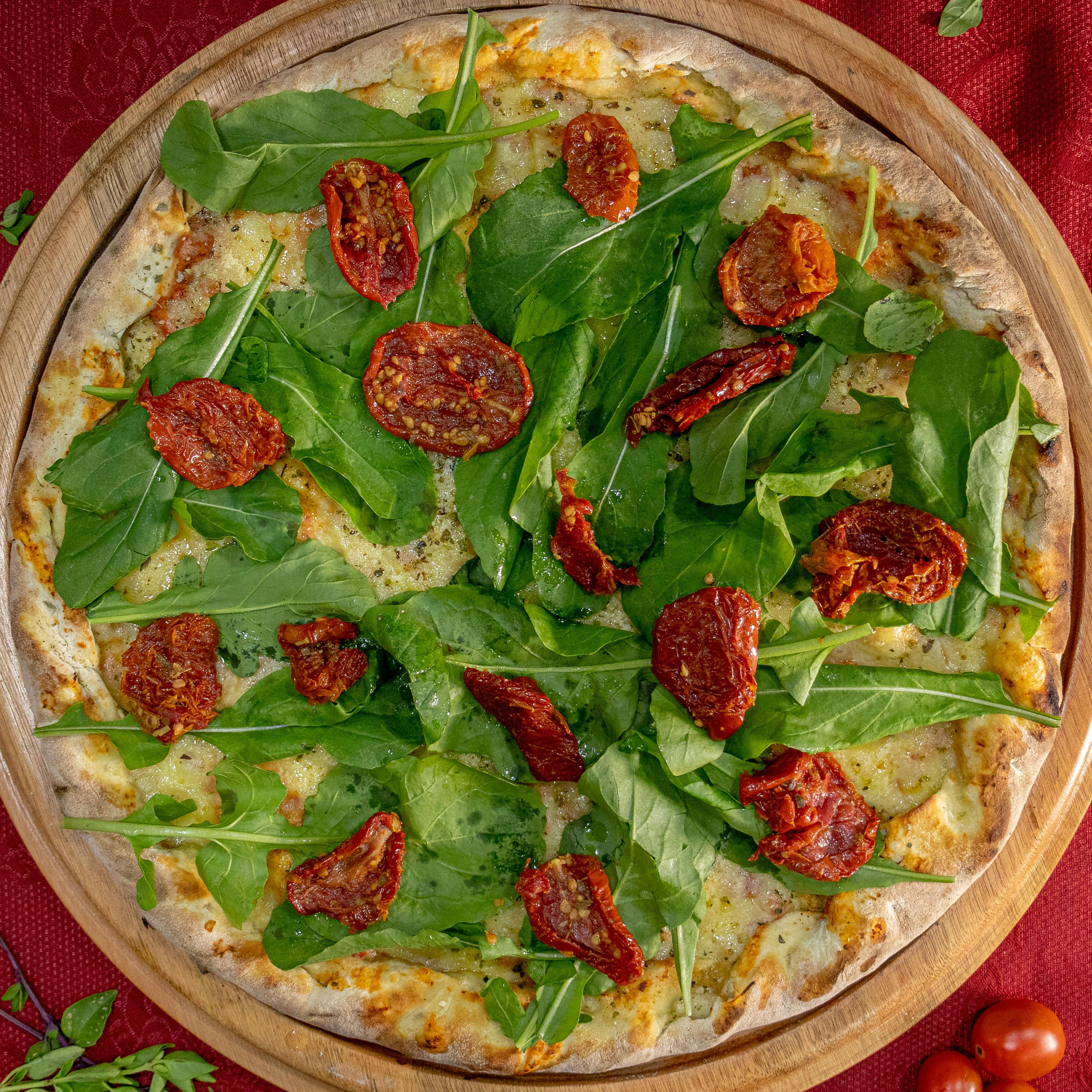 Flatbread topped with rocket and sunblush tomatoes, showing one way to use semi-dried tomatoes for an easy lunch or antipasti-style meal.